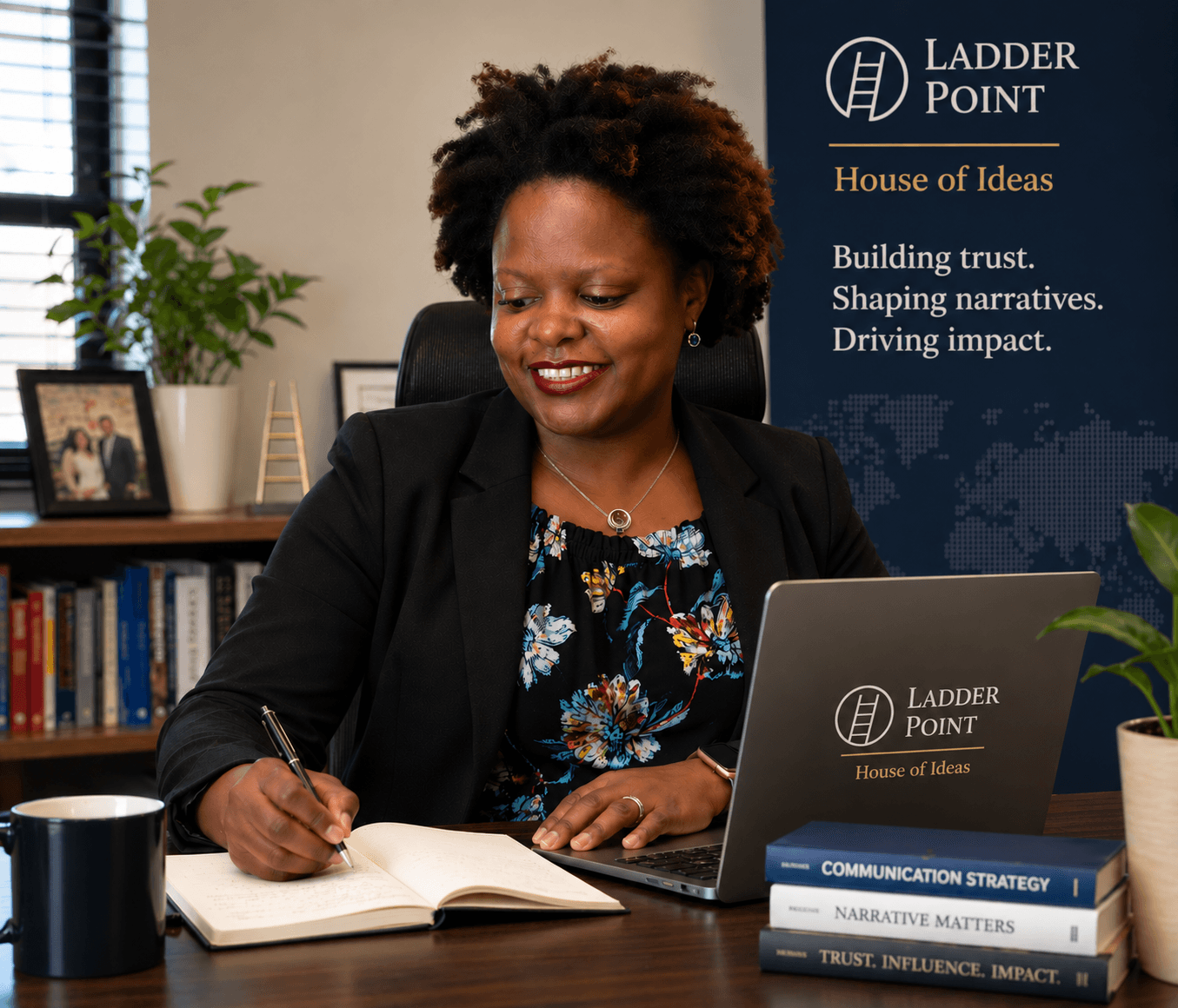 Doreen Hove working at her desk with Ladder Point branding